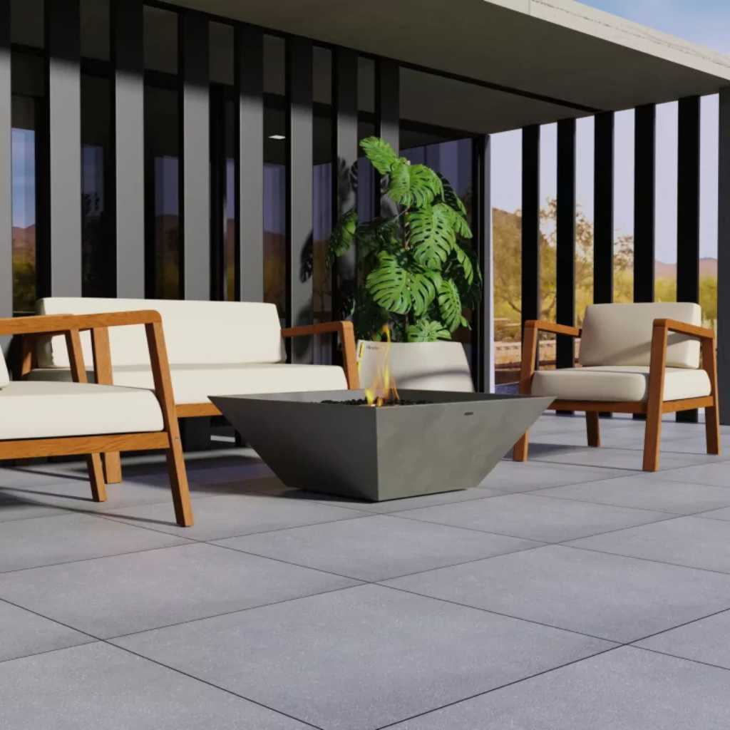 Modern outdoor fire feature beside stone patio seating