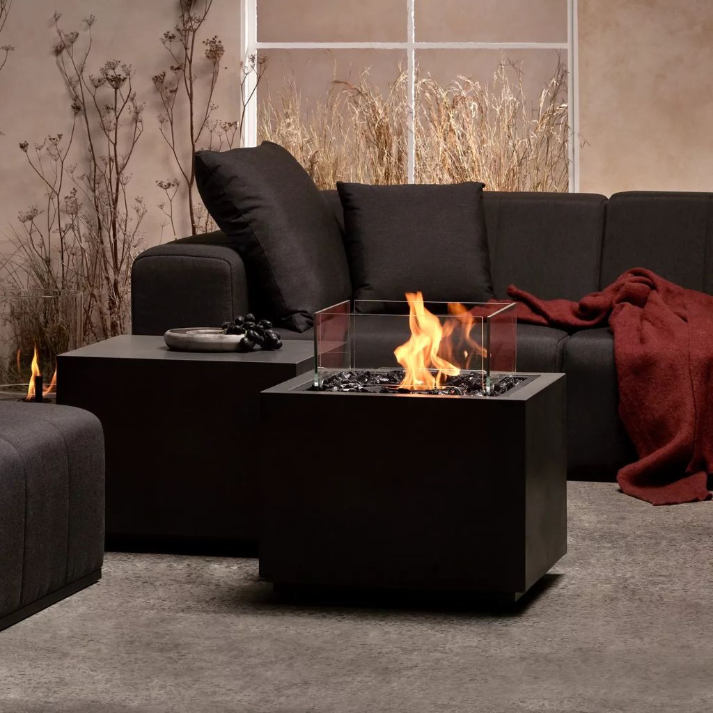 Sidecar 24 Fire Pit Table in graphite finish styled in a modern living room
