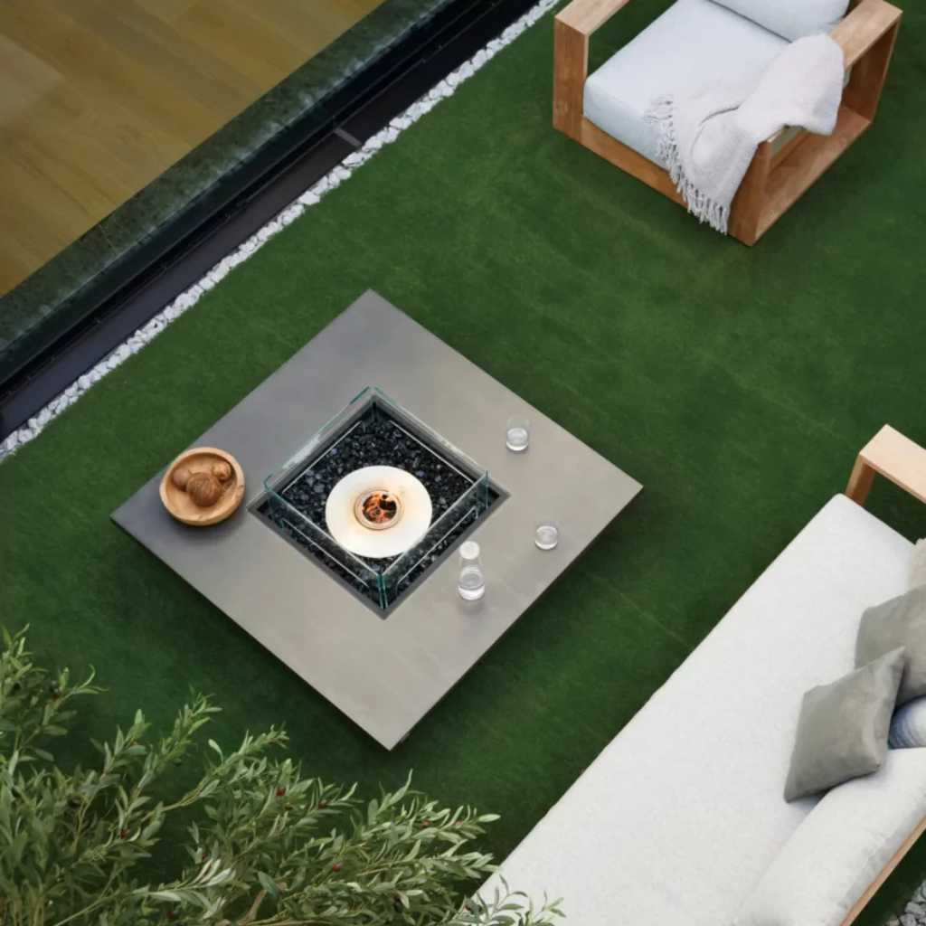 Top-view outdoor décor arrangement with a concrete centerpiece and surrounding accessories.