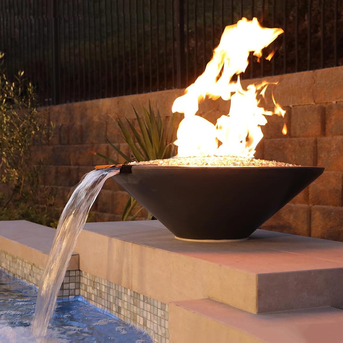 Geo Round Fire And Water Bowl (material: Gfrc) water/fire feature that is plumbed with a lip so water can be pumped from underneath and spill into a basin. the fire feature runs on liquid propane or natural gas.